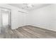Bedroom featuring wood-look floors, ceiling fan, and closet with double doors at 11988 117Th St, Seminole, FL 33778
