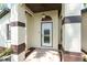 The front exterior showcases an inviting front door framed by columns and decorative trim at 11988 117Th St, Seminole, FL 33778