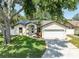 Charming single-story home with a well-maintained lawn and a two-car garage at 11988 117Th St, Seminole, FL 33778