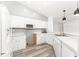 Bright kitchen features white cabinets, stainless steel appliances, and modern pendant lighting at 11988 117Th St, Seminole, FL 33778