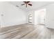 A bright living room with fresh, neutral paint and modern wood-look flooring features a ceiling fan at 11988 117Th St, Seminole, FL 33778
