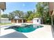 Backyard view of the in-ground pool, spa, covered structure and storage shed at 11988 117Th St, Seminole, FL 33778