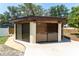 Pool house featuring screened windows and stucco siding at 11988 117Th St, Seminole, FL 33778