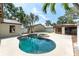 Backyard pool area with the pool, jacuzzi, and outdoor lounging space at 11988 117Th St, Seminole, FL 33778
