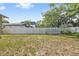 Fenced backyard featuring a combination of mature trees and a grassy lawn at 1203 E New Orleans Ave, Tampa, FL 33603