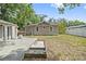 Backyard with white fencing, deck, patio, and mature landscaping at 1203 E New Orleans Ave, Tampa, FL 33603