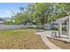 Spacious backyard with a white fence and detached shed offering privacy at 1203 E New Orleans Ave, Tampa, FL 33603