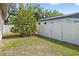Backyard with white fencing and mature trees and shrubs at 1203 E New Orleans Ave, Tampa, FL 33603