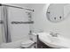 Bright bathroom featuring a shower over tub with white subway tile and black accent, plus an updated vanity and lighting at 1203 E New Orleans Ave, Tampa, FL 33603