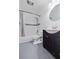 Bathroom featuring a shower over tub with white subway tile and black accent, plus an updated vanity with black cabinets at 1203 E New Orleans Ave, Tampa, FL 33603