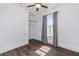Bedroom with a closet, ceiling fan, hardwood floors, and a window with gray curtains at 1203 E New Orleans Ave, Tampa, FL 33603