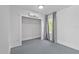 Bedroom showcases a mini-split, window, and closet with neutral walls and gray floors at 1203 E New Orleans Ave, Tampa, FL 33603