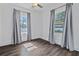 Bright bedroom featuring hardwood floors, ceiling fan, and window at 1203 E New Orleans Ave, Tampa, FL 33603