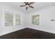 Cozy bedroom with dark hardwood floors, two windows, and detailed ceiling at 1203 E New Orleans Ave, Tampa, FL 33603