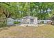 Detached garage featuring a modern door and concrete patio at 1203 E New Orleans Ave, Tampa, FL 33603