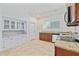 Well-lit kitchen with tile flooring, granite countertops, and stainless-steel appliances at 1203 E New Orleans Ave, Tampa, FL 33603