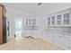 Bright kitchen with tile flooring, white cabinets, and a view into another room at 1203 E New Orleans Ave, Tampa, FL 33603