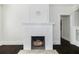 Close-up view of living room fireplace with white tile surround and decorative wood mantel at 1203 E New Orleans Ave, Tampa, FL 33603
