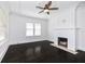 Bright living room with dark hardwood floors and a decorative tiled fireplace at 1203 E New Orleans Ave, Tampa, FL 33603