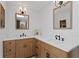 Bathroom featuring wood cabinets, double sinks, and designer mirrors at 125 Live Oak Ln, Largo, FL 33770