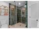Bathroom featuring a stylish glass shower with modern tile and shelving at 125 Live Oak Ln, Largo, FL 33770