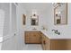 Bathroom with wood cabinets, double sinks, and black fixtures at 125 Live Oak Ln, Largo, FL 33770