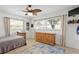 Bright bedroom with light tile flooring, natural light from the windows, and ceiling fan at 125 Live Oak Ln, Largo, FL 33770