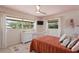 Cozy bedroom with pink ceiling and white trim features a large window and natural lighting at 125 Live Oak Ln, Largo, FL 33770