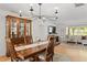 Dining room with hardwood floors, a large wooden table with seating, and a hutch in the background at 125 Live Oak Ln, Largo, FL 33770
