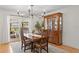 Dining room with hardwood floors, a large wooden table with seating, and natural light from the patio doors at 125 Live Oak Ln, Largo, FL 33770