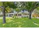 Well-maintained home featuring a manicured front lawn and mature shade trees at 125 Live Oak Ln, Largo, FL 33770