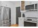 Modern kitchen with stainless steel appliances, white cabinets, subway tile backsplash, and hardwood floors at 125 Live Oak Ln, Largo, FL 33770