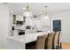 Bright kitchen features white cabinets, subway tile backsplash, quartz countertops and large island with seating at 125 Live Oak Ln, Largo, FL 33770