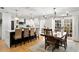 Open concept kitchen with a large island, pendant lighting, and a dining area with modern chandelier at 125 Live Oak Ln, Largo, FL 33770