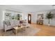 Inviting living room with a sectional sofa, large window, hardwood floors, and stylish décor at 125 Live Oak Ln, Largo, FL 33770