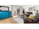 Cozy living room featuring a leather sofa, area rug, and sliding doors to the outdoor space at 125 Live Oak Ln, Largo, FL 33770