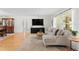 Bright living room with wood floors, a large window, and a comfortable sectional sofa at 125 Live Oak Ln, Largo, FL 33770