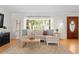 Bright living room featuring a large window, hardwood floors, and a comfortable sofa with stylish decor at 125 Live Oak Ln, Largo, FL 33770