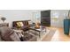 Comfortable living room features leather seating, a fireplace, hardwood floors, and a cozy atmosphere at 125 Live Oak Ln, Largo, FL 33770