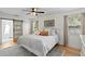 Serene bedroom with a king-size bed, soft lighting, and a sliding barn door to the ensuite bathroom at 125 Live Oak Ln, Largo, FL 33770