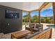 Outdoor patio with comfortable seating and an outdoor TV at 125 Live Oak Ln, Largo, FL 33770