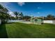 Expansive backyard with a refreshing pool, well-maintained lawn, and privacy fencing at 12873 Cumberland Dr, Largo, FL 33773