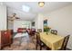 Dining area with tile flooring is adjacent to the living room and features a view of the outdoor landscape at 12873 Cumberland Dr, Largo, FL 33773