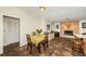 Cozy dining area features a table with seating for four, tile flooring, and a view of the fireplace at 12873 Cumberland Dr, Largo, FL 33773
