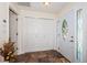Bright entryway with ceramic tile floors, a storage closet and a beautiful stained-glass window in the door at 12873 Cumberland Dr, Largo, FL 33773