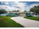 Charming single-story home features a well-manicured lawn, spacious driveway and an attached two-car garage at 12873 Cumberland Dr, Largo, FL 33773