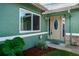 Welcoming front entryway features a decorative front door with sidelights, lush landscaping, and a stone accent at 12873 Cumberland Dr, Largo, FL 33773