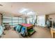 Spacious garage has a billiards table and extra storage at 12873 Cumberland Dr, Largo, FL 33773