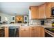 Contemporary kitchen with stainless steel appliances, breakfast bar, and view to a living area with fireplace at 12873 Cumberland Dr, Largo, FL 33773