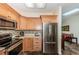 Modern kitchen features stainless steel appliances, light wood cabinets, and opens to the living area for seamless entertaining at 12873 Cumberland Dr, Largo, FL 33773